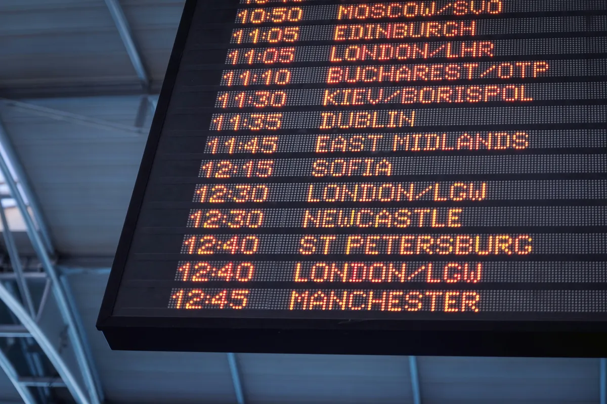 Departure board inside an airport terminal