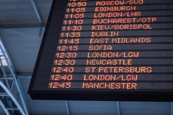 Departure board inside an airport terminal