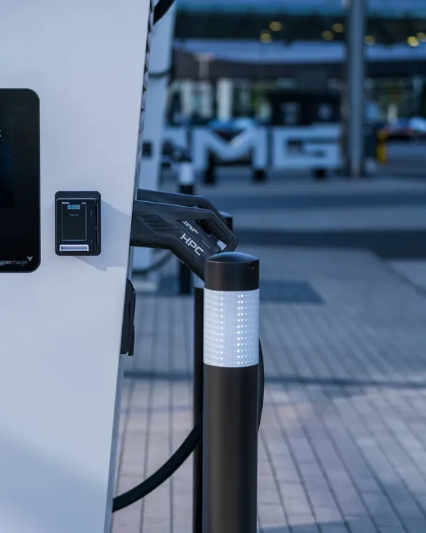 Electric vehicle plugged into a charging station