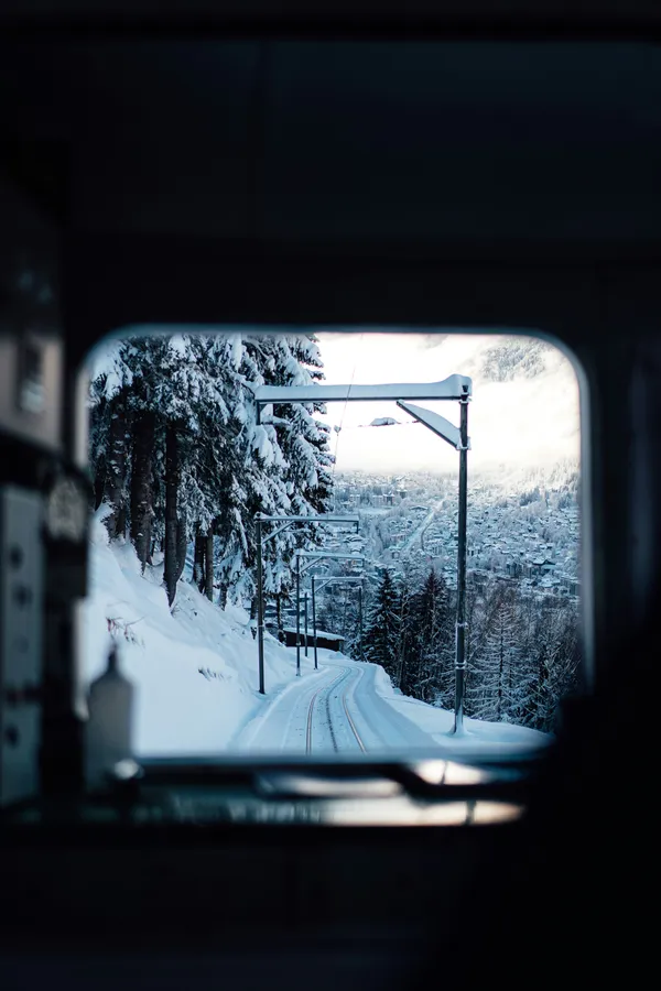 Snowy road seen through a car window